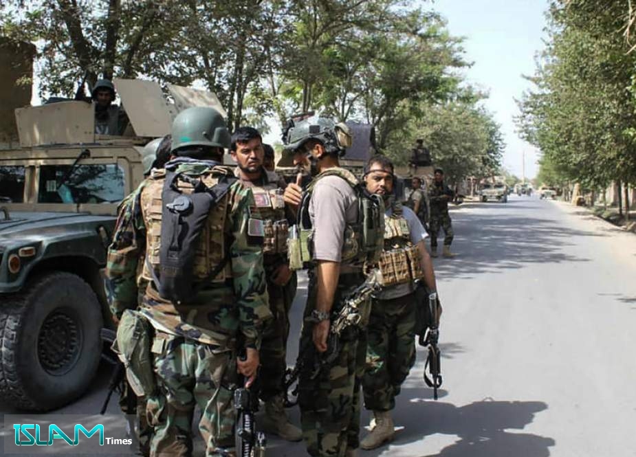 Afghan security forces gather at a street in Kunduz, Afghanistan