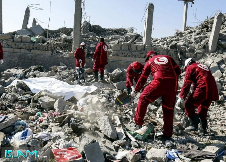 First responders search for victims from under the rubble of a destroyed building that was used as a detention center which was hit by a Saudi airstrike in Dhamar Province