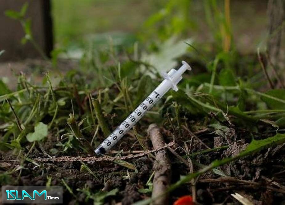 A used needle sits on the ground in a park in Lawrence, Massachusetts, the US, on May 30, 2017
