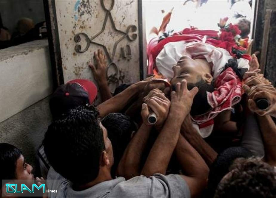 Palestinian mourners carry away the body of 17-year-old Ali al-Ashqar, one of two Palestinian youths who was killed the previous day by Israeli fire, during his funeral at Jabalia refugee camp in the northern Gaza Strip on September 7, 2019.