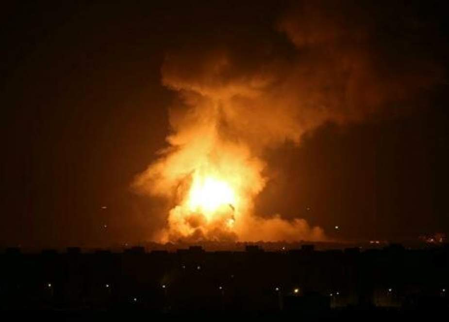Flames and smoke are seen during the Israeli airstrikes on the central Gaza Strip.jpg