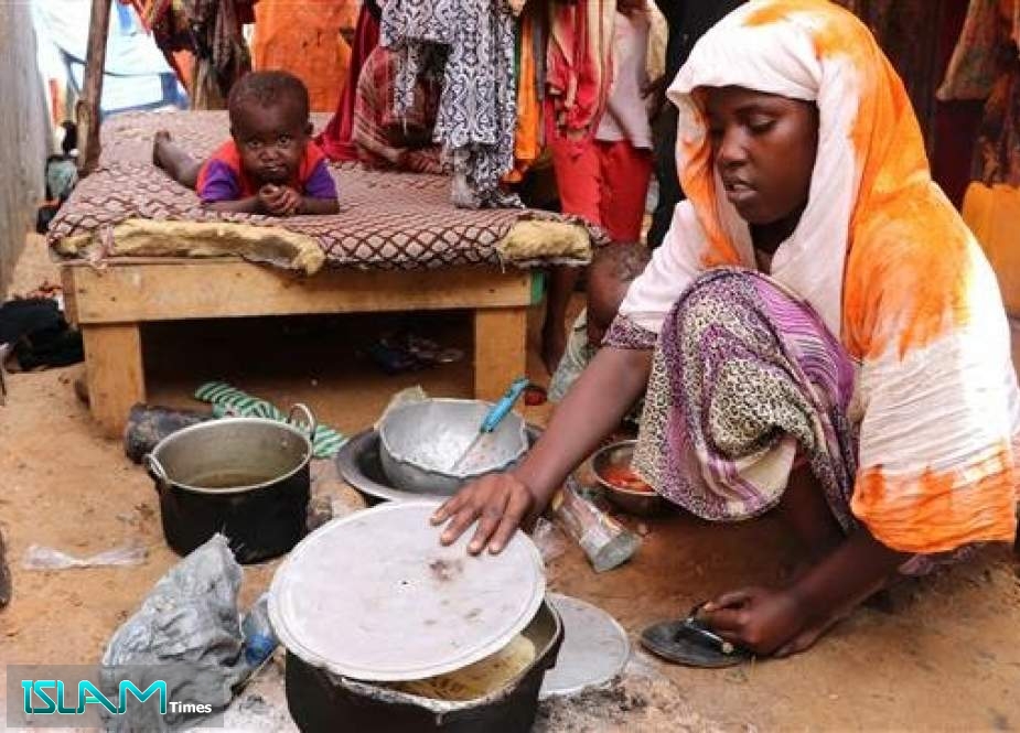 A newly arrived woman fleeing from the drought affected areas in the Lower Shabelle Region cooks for her family at al-Adala internally displaced people (IDP) camp just outside of the Somali capital Mogadishu on May 15, 2019