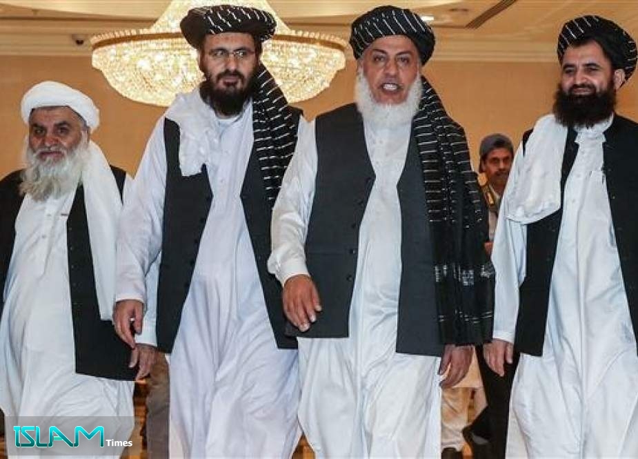 The photo taken on July 8, 2019 shows Taliban negotiators walking during the second day of Afghan talks in Doha, Qatar.