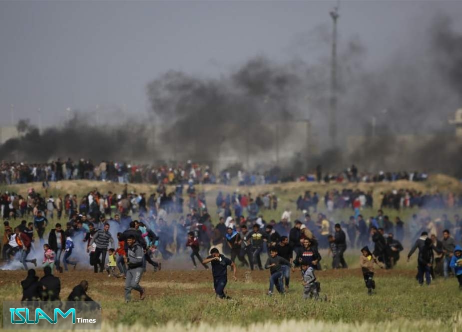 Tear gas is fired at protesters during clashes with Israeli regime forces near the border between the Gaza strip and Israel, east of Gaza City