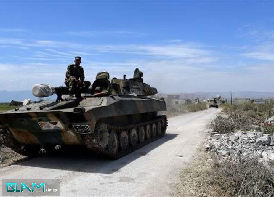 Syrian forces enter the town of Kafr Nabuda, about 40 kilometers north of Hama, May 11, 2019