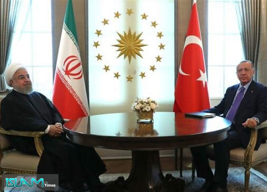 Turkish President Recep Tayyip Erdogan (R) and Iranian President Hassan Rouhani (L) pose before their meeting at the Presidential Palace in Ankara on September 16, 2019.
