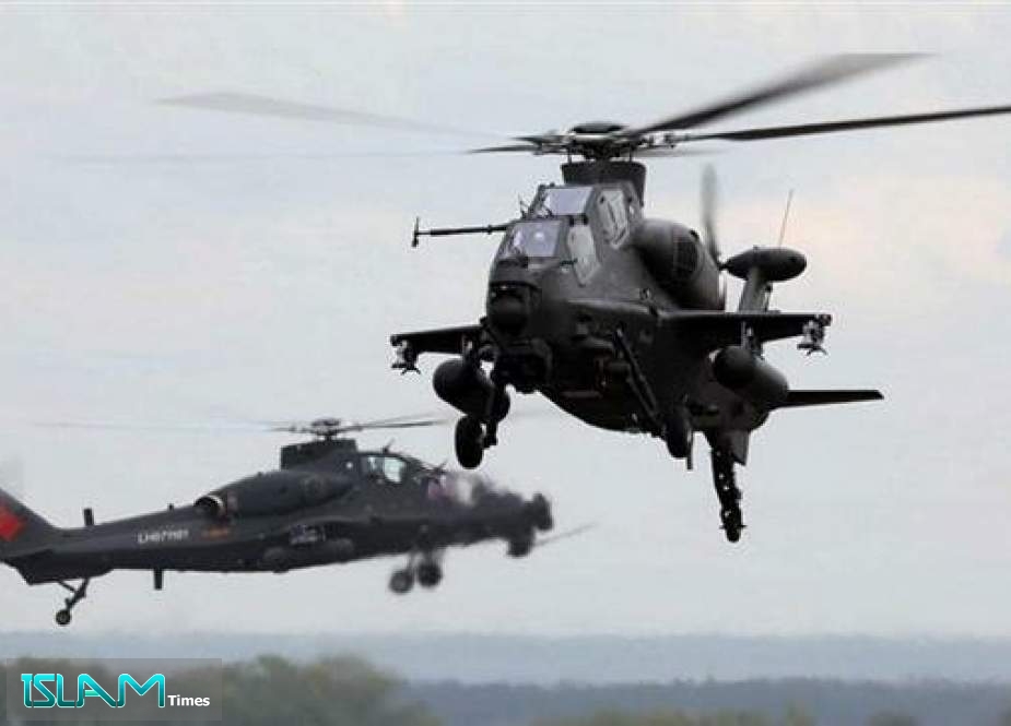 A handout photo made available by Russia’s military shows two Changhe Aircraft Industries Corp. Z-10 combat helicopters of the Chinese army landing at an airport of Cheliabinsk, Russia on September 6.