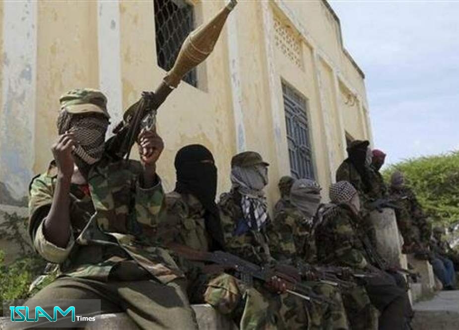 Al-Shabab militants sit outside a building during patrol along the streets of Dayniile district in southern Mogadishu, March 5, 2012.