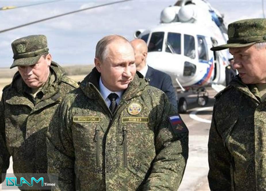 Russian President Vladimir Putin (C), Defense Minister Sergei Shoigu (R) and Chief of the General Staff of Russian Armed Forces Valery Gerasimov visit the firing range Donguz to oversee military drills in Orenburg Region, September 20, 2019.