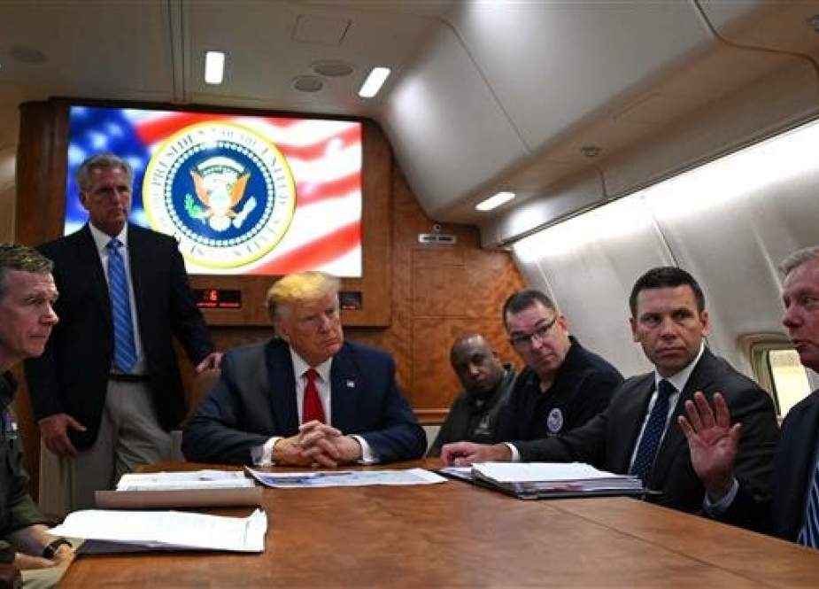 US President Donald Trump holds a meeting aboard Air Force One.jpg