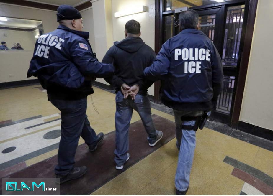 In this March 3, 2015, photo, Immigration and Customs Enforcement officers escort an arrestee in an apartment building in the Bronx borough of New York during a series of early morning raids.
Richard Drew/AP