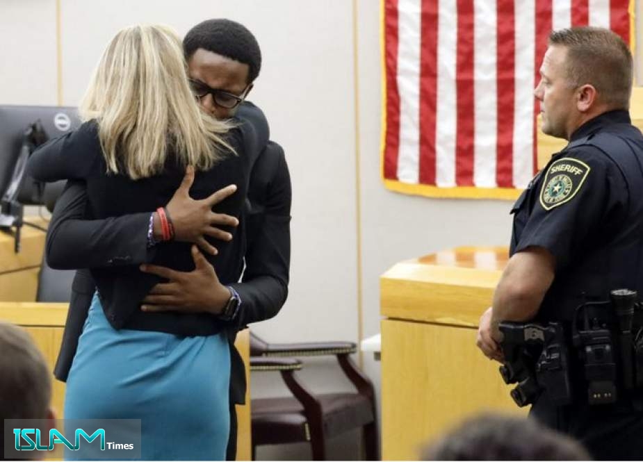 Brandt Jean embraces former Dallas police officer Amber Guyger after she was convicted for murdering his brother, Botham. (Tom Fox / The Dallas Morning News via AP)