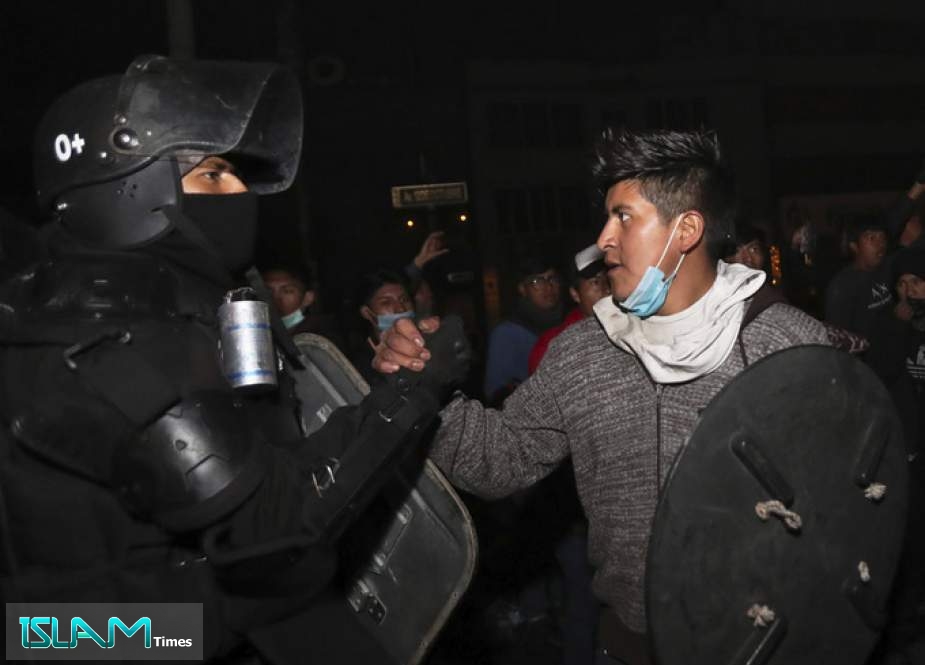 A protester shakes hands with a security officer in Quito, Ecuador, on Sunday as they celebrate the government