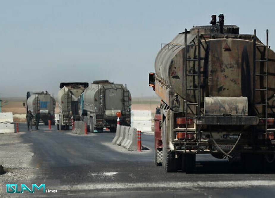 File: In this April 4, 2018 photo, a convoy of oil trucks passes a Kurdish police checkpoint as they move fuel produced in Kurdish-held areas in Syris (AP Photo/Hussein Malla)