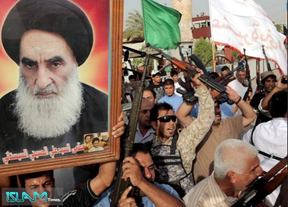 An Iraqi man holds a picture of Grand Ayatollah Ali al-Sistani