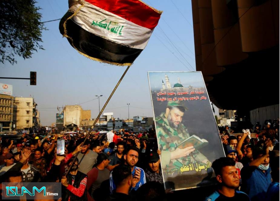 Mourners in Baghdad carry a coffin of a demonstrator who was killed at an anti-government protest, while others carry a picture of Iraqi Shia cleric Moqtada al-Sadr (Reuters)
