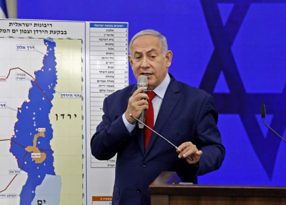 Benjamin Netanyahu speaks before a map of the Jordan Valley, which he wants to annex.jpg