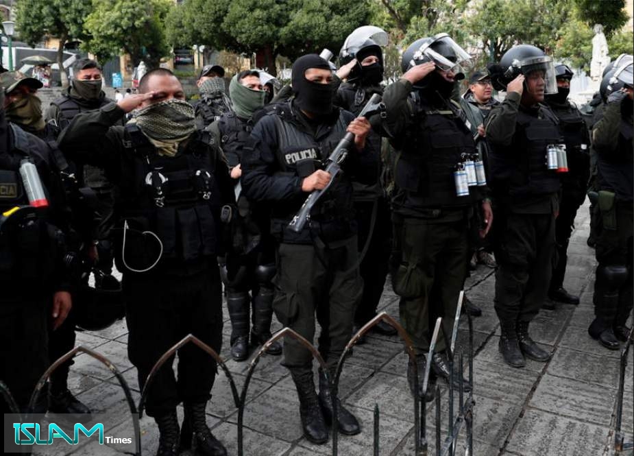 Armed police stand near the presidential palace in La Paz, Bolivia