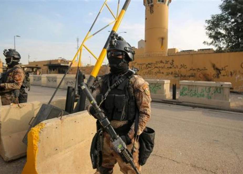 Iraqi forces stand guard in front of the US embassy in Baghdad.jpg