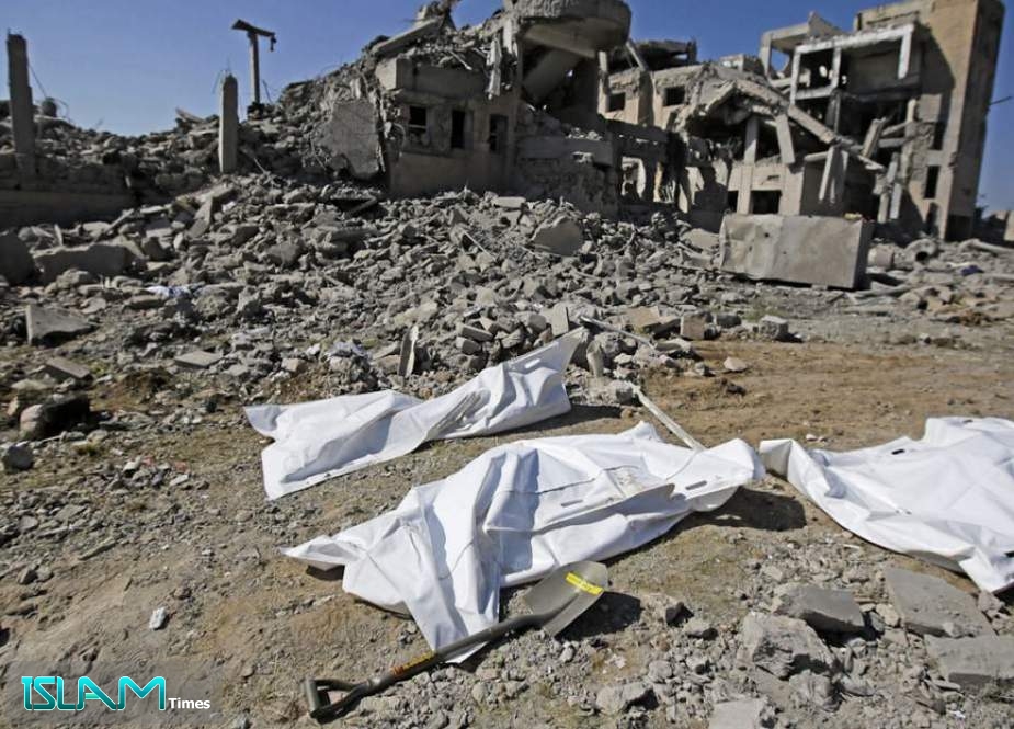 Bodies covered in plastic lie on the ground amid the rubble of a building destroyed by Saudi-led airstrikes, that killed at least 60 people and wounding several dozen more