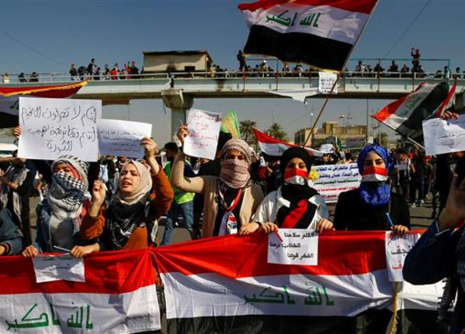 University students hold banners as they gather during ongoing protests in Baghdad, Iraq.jpg