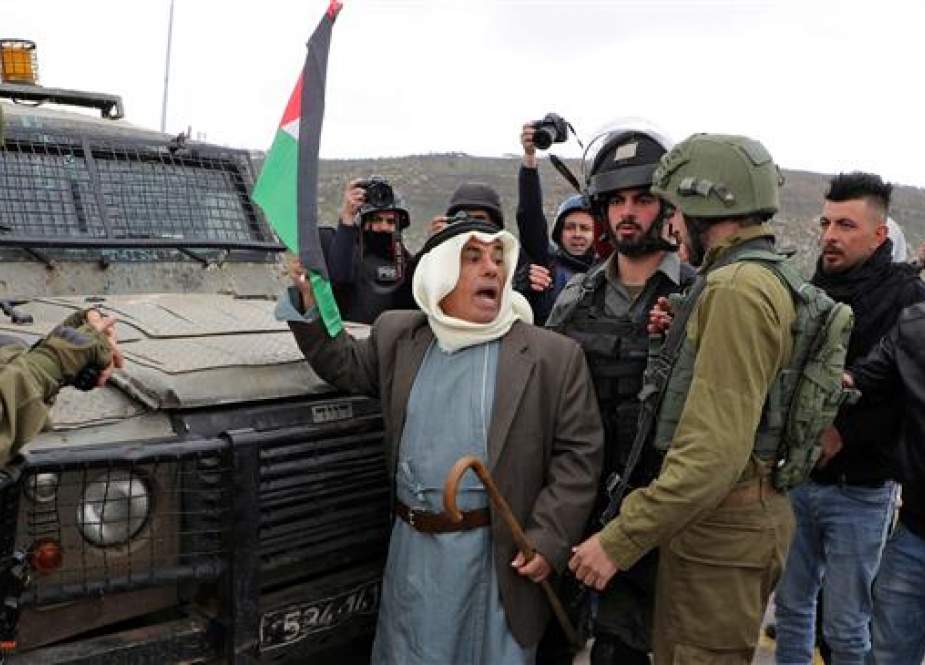 Palestinian protester is confronted by Israeli forces.jpg