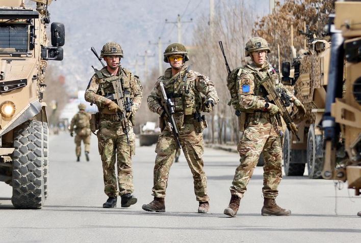 British soldiers stand guard at the site where gunmen attacked a political gathering in Kabul.