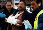 Afghan health workers carry a wounded man from a hospital after gunmen attacked a political gathering in Kabul. EPA