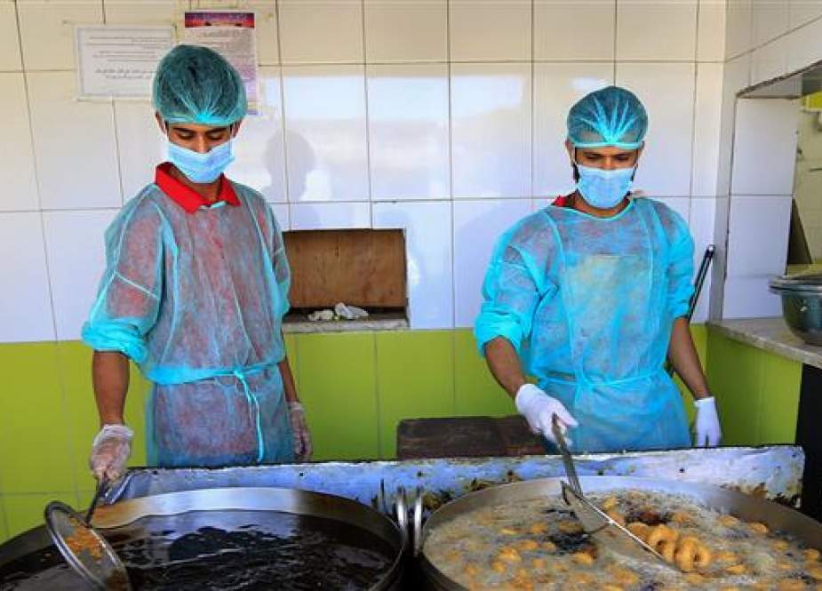 Kitchen staff prepare food at a restaurant in the Yemeni capital Sana’a.jpg