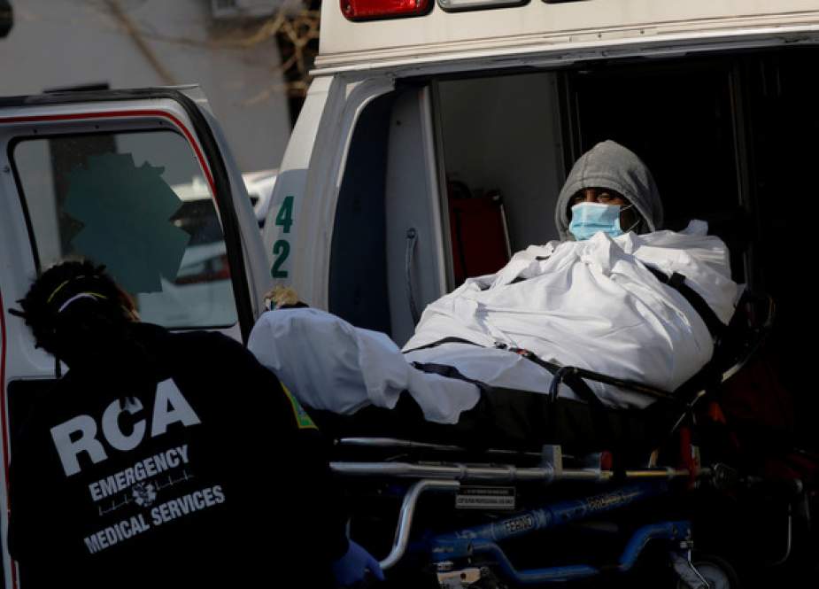 EMTs load a patient into an ambulance outside the Brooklyn Hospital Center in New York City, US.JPG