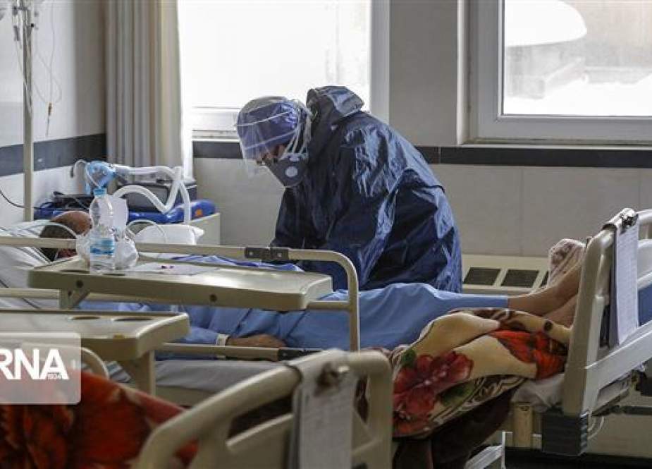 Medic treating a patient infected with the new coronavirus at a hospital in Tehran, Iran.jpg