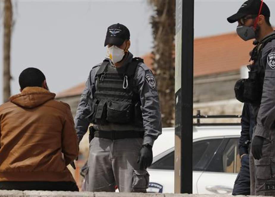 Members of the Israeli security forces, wearing protective face masks.jpg