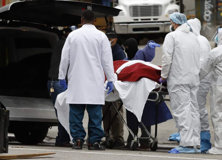 Workers load the body of a deceased person into vehicle outside The Brooklyn Hospital Center.JPG