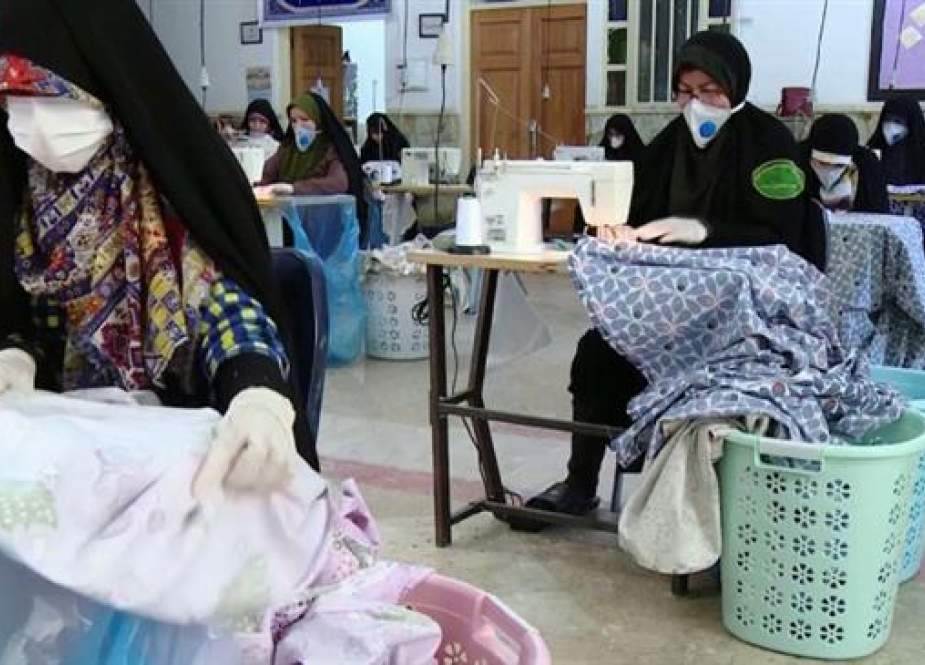 Iranian women volunteer to sew masks and protective gowns to fight the spread of coronavirus in Tehran..jpg