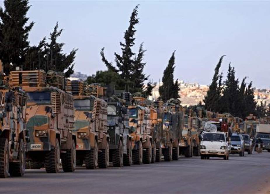 Turkish military convoy is seen parked near the town of Batabu on the highway Idlib.jpg