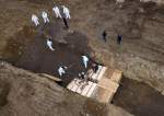 Workers in Full Hazmat Suits Bury Rows of Coffins in Mass Grave  <img src="https://www.islamtimes.org/images/picture_icon.gif" width="16" height="13" border="0" align="top">