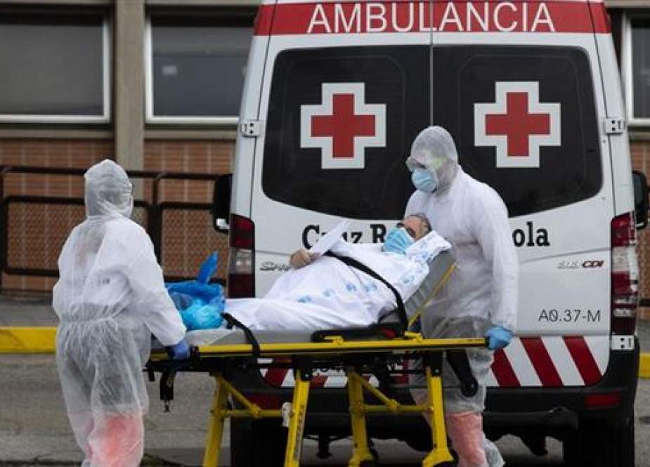 Emergency workers wearing full protective suits at the Severo Ochoa Hospital in Leganes, Spain.jpg