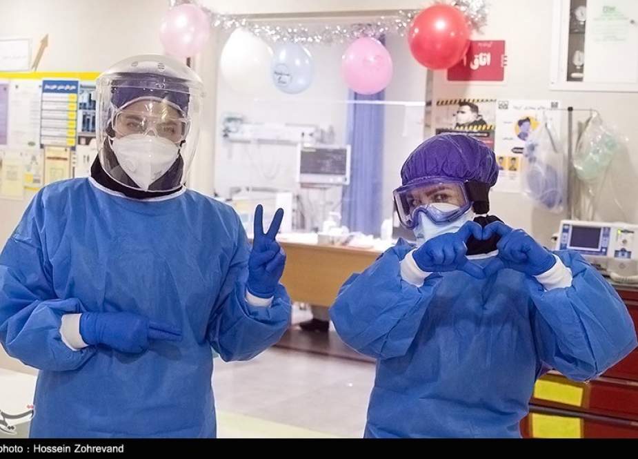 Iranian nurses flashing victory and love sign at a hospital treating coronavirus patients.jpg
