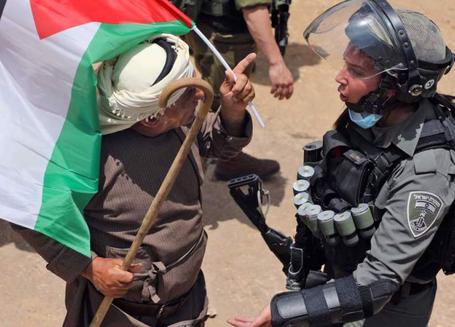 Palestinian protestor shouts at an Israeli soldier during a demonstration against Israeli occupation.jpg