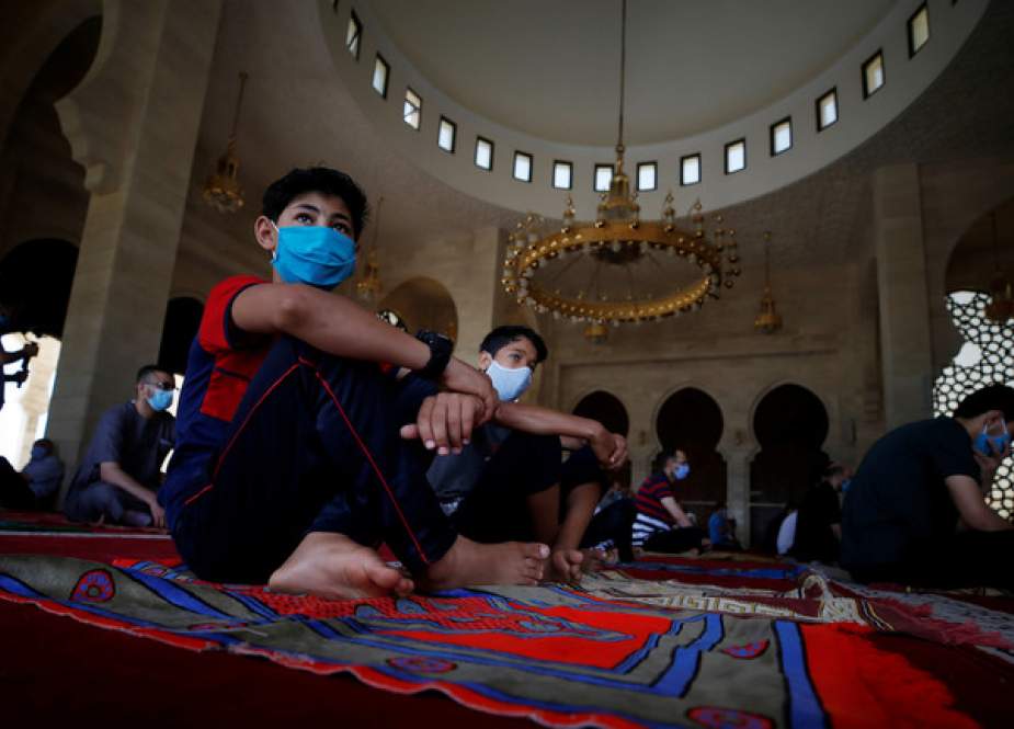 Palestinians wearing masks attend Friday prayers in a Gaza mosque.JPG
