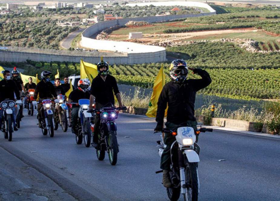 Supporters of Hezbollah ride motorcycles carrying the group’s flags in the southern Lebanese.jpg