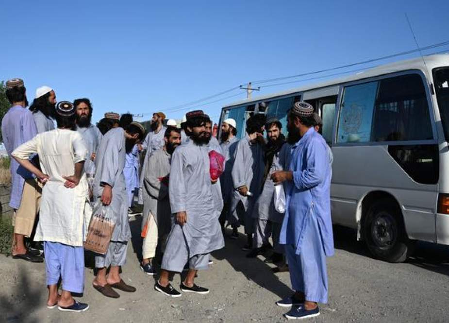 Taliban prisoners walk out vehicles after their release from the Bagram prison.jpg