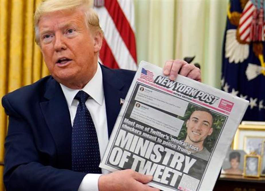 President Donald Trump holds up a copy of the New York Post.jpg