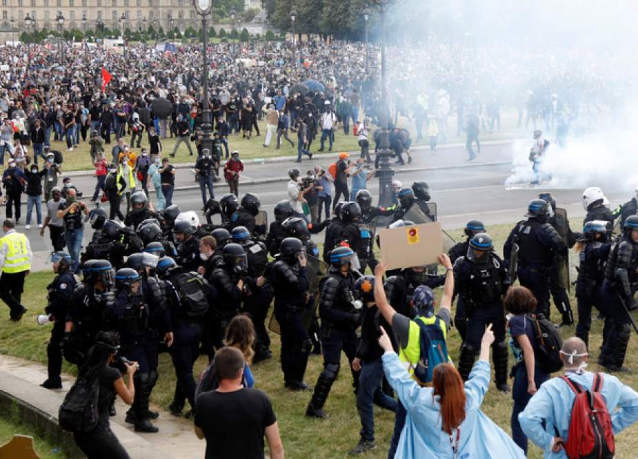 Protesters face off with police during a demonstration by health workers in Paris, France.JPG