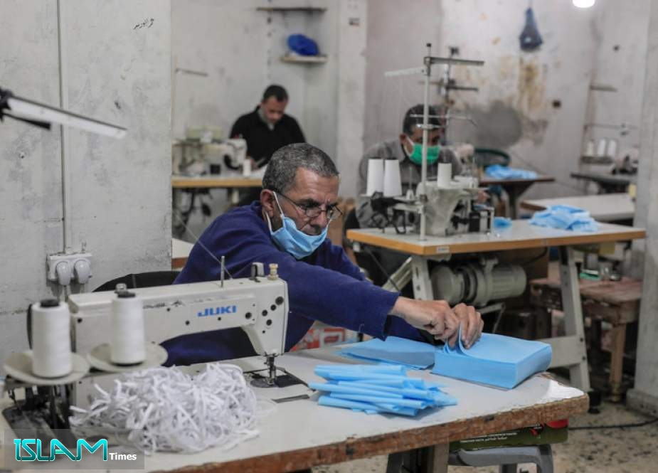 Workers sew medical masks for export to Israel in a workshop in Gaza City on 12 April 2020.  Mohammed Zaanoun ActiveStills