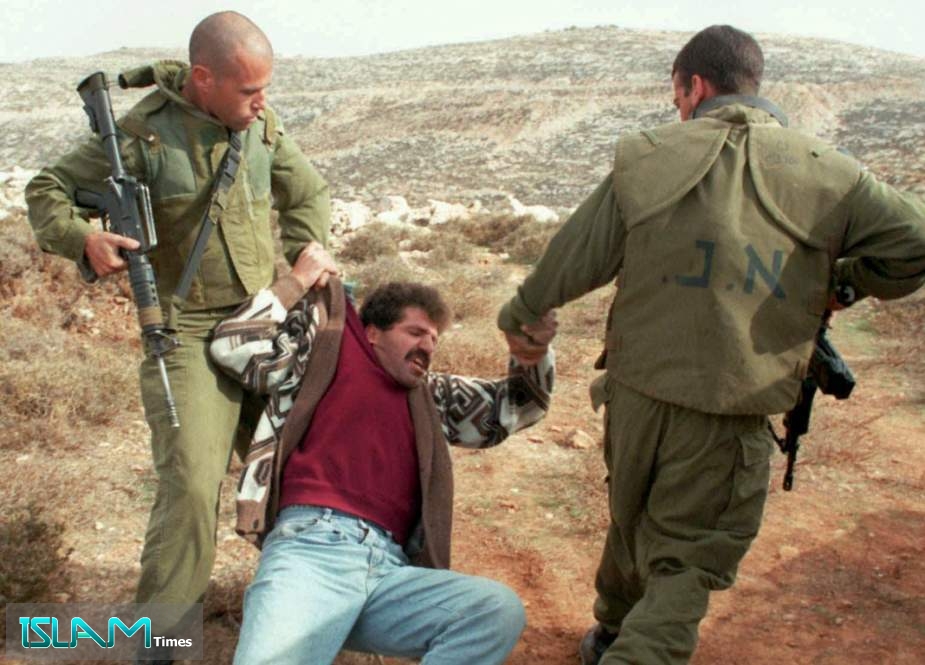 Two Israeli soldiers drag a Palestinian to the ground, Nov. 19, 1996 as he protests the bulldozing of his land near the Jewish settlement of Efrat in the West Bank.
