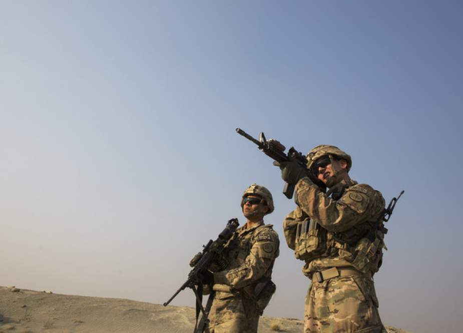 US soldier from the 3rd Cavalry Regiment uses the optic on his rifle to observe Afghans.JPG