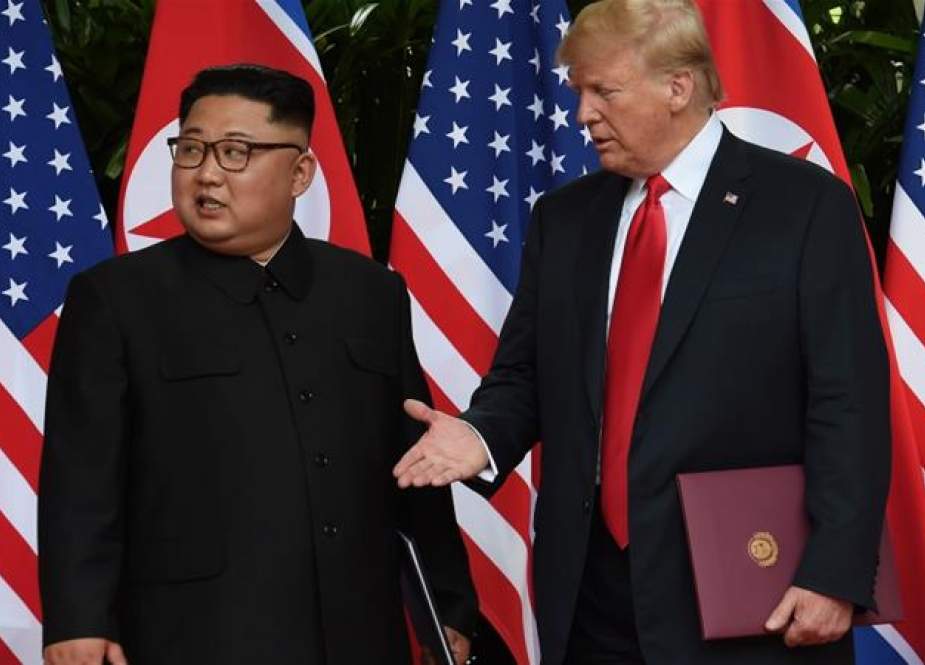 Donald Trump and Kim Jong-un during a summit at the Capella Hotel on Sentosa island in Singapore.jpg