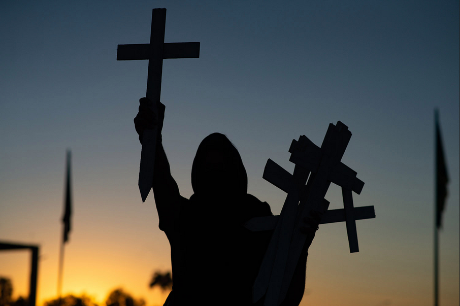 A protester carries crosses in front of the National Congress in Brasilia, Brazil, on June 28 during a demonstration against Brazilian President Jair Bolsonaro and in memory of the people who have died from the coronavirus. Andressa Anholete/Getty Images