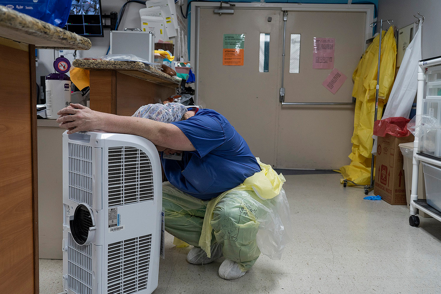 A medical staff member rests in front of a fan in the coronavirus intensive care unit at United Memorial Medical Center in Houston on June 30. Coronavirus cases and hospitalizations have spiked since Texas reopened, pushing intensive care wards to full c